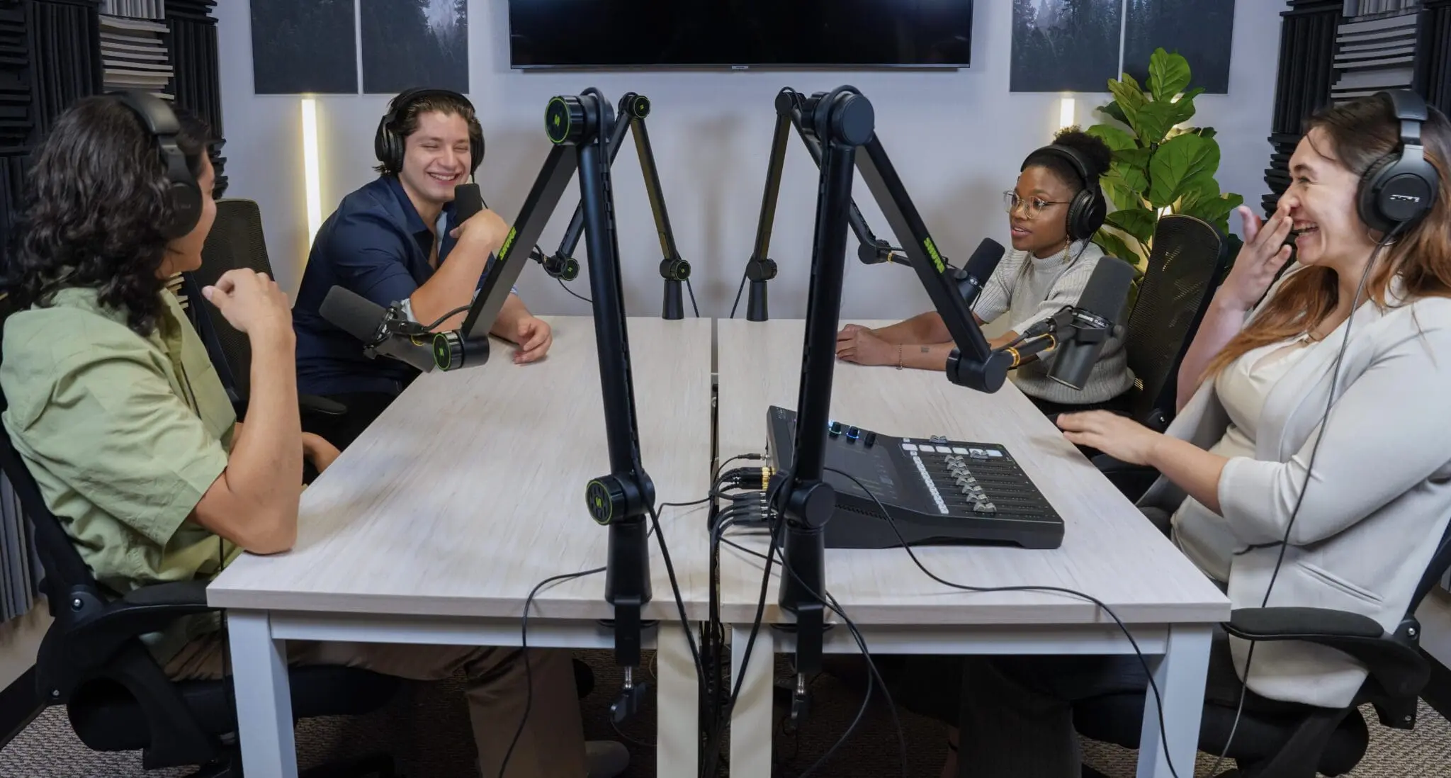 Podcasters sitting at a table recording an episode