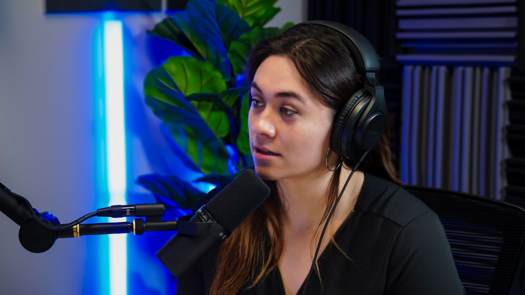 Podcast host, woman watching her guests speak