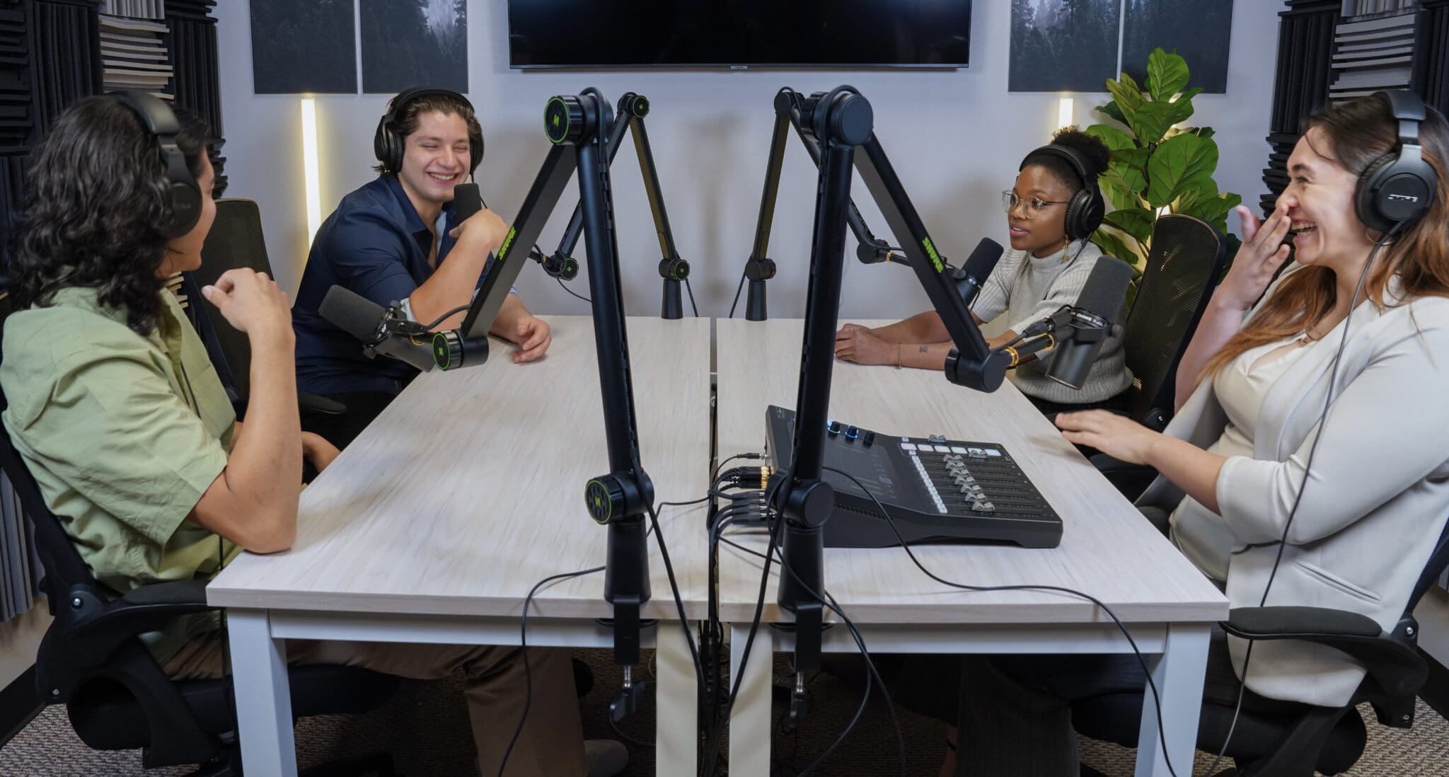 Podcasters sitting at a table recording an episode