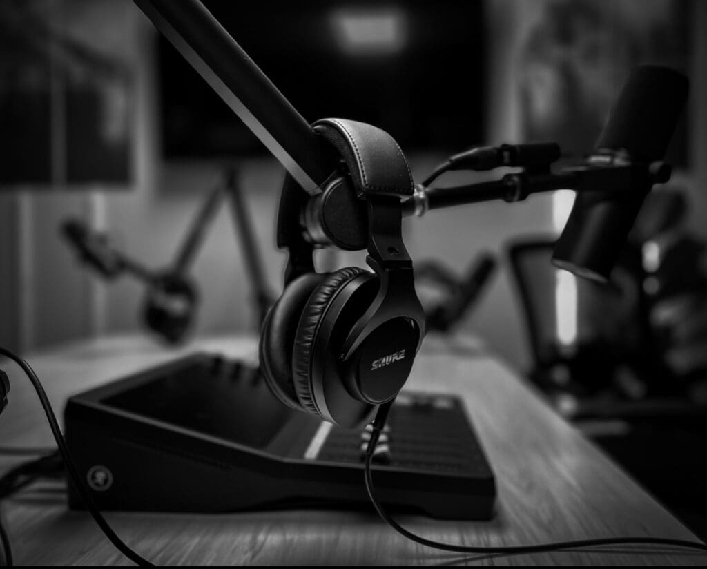 Headphones hanging from a microphone stand