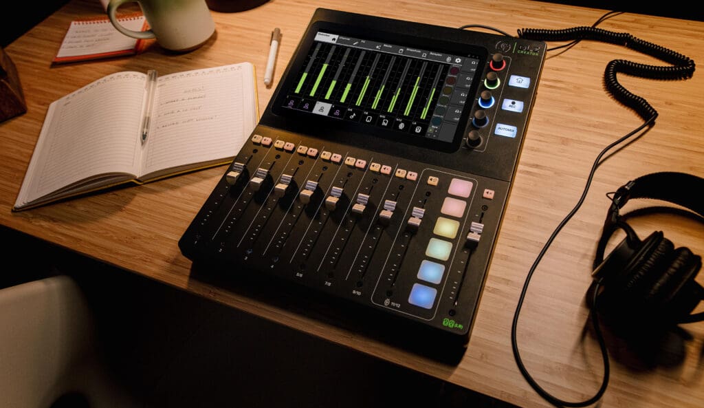 Photo of desktop mixer on desk with headphones.