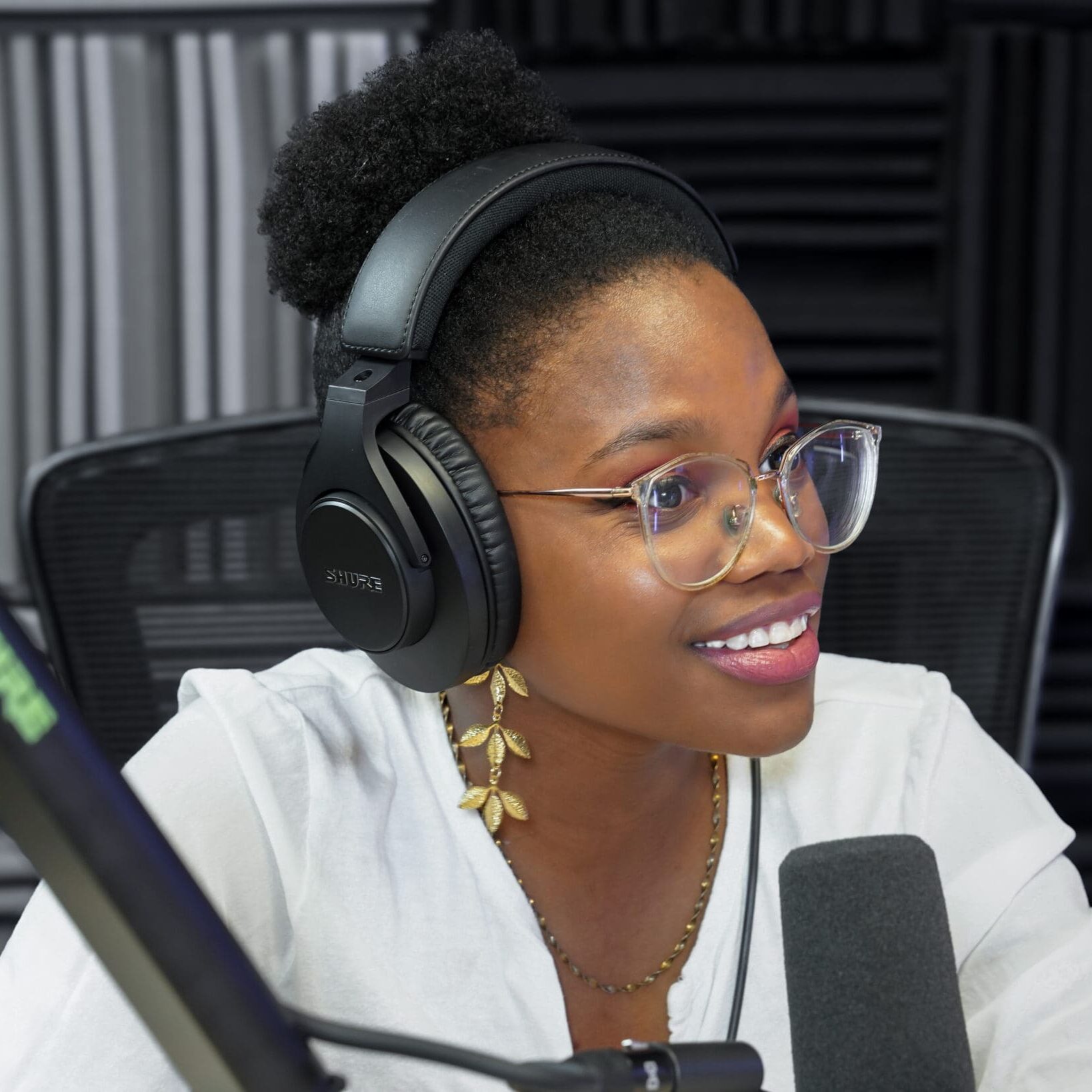 Podcast guest, woman speaking into microphone and smiling