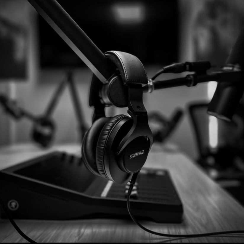 Headphones hanging from a microphone stand